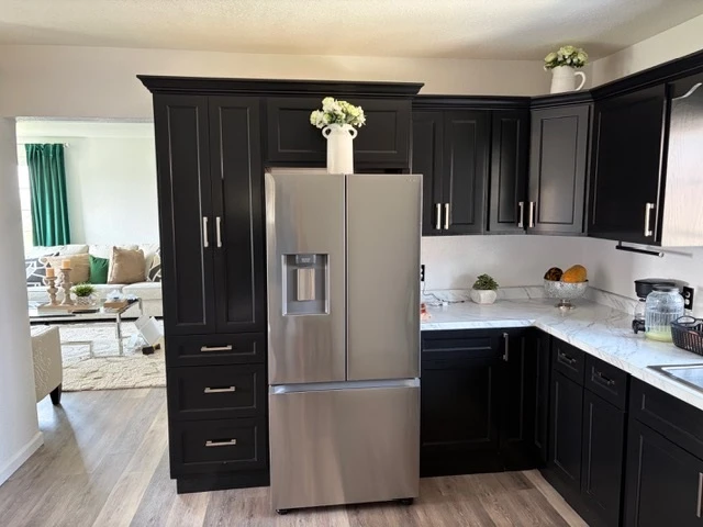 A dark shaker kitchen with white quartz counters, built and installed by MPS Finish Carpentry