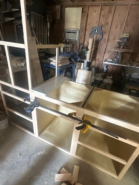 Cabinet face frames glued and clamped on the bench in the Grandview shop